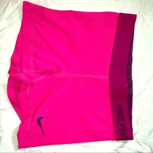 Hot pink Nike Pros with maroon waistband
